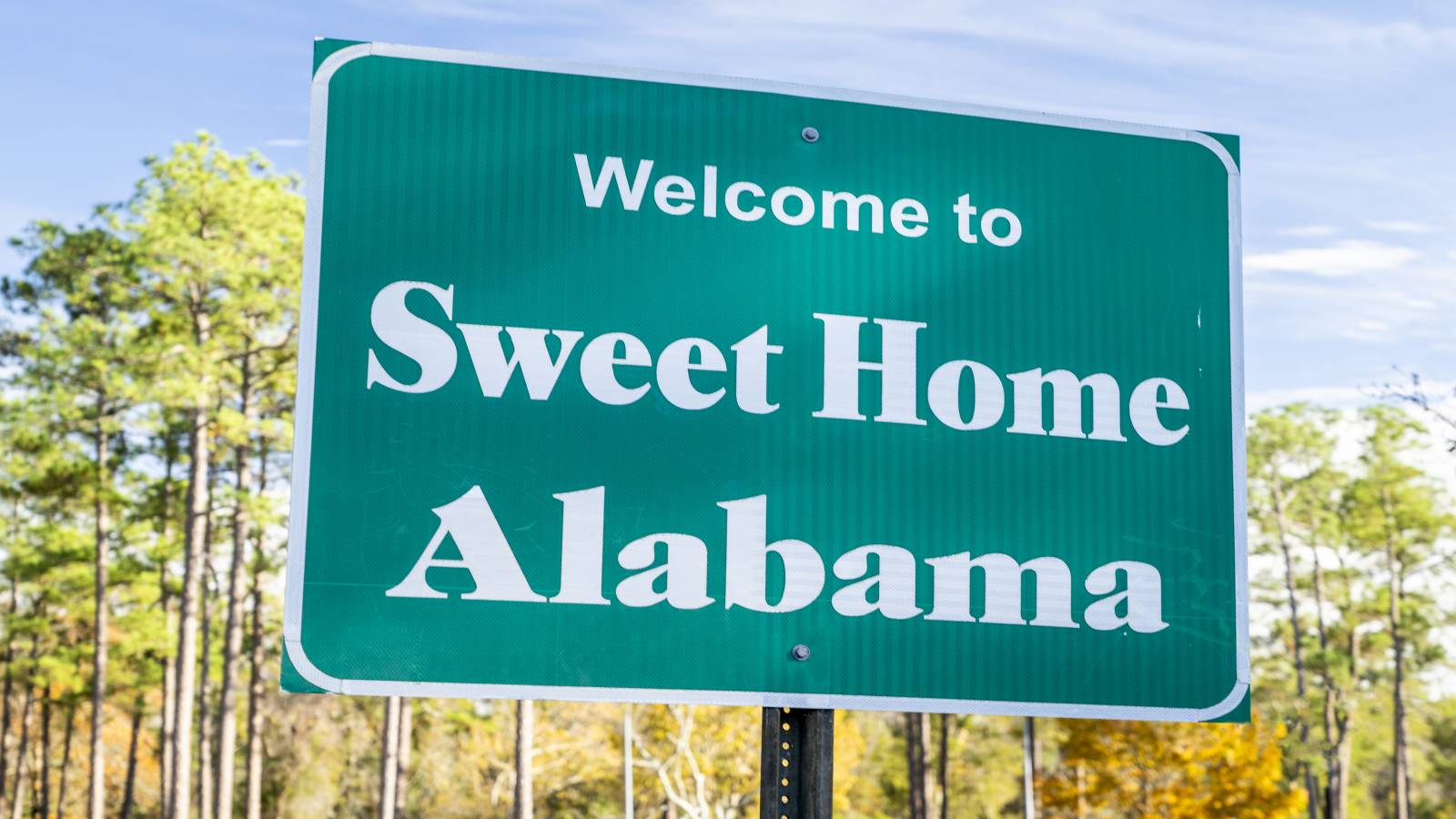 A Welcome to Alabama sign beside a highway