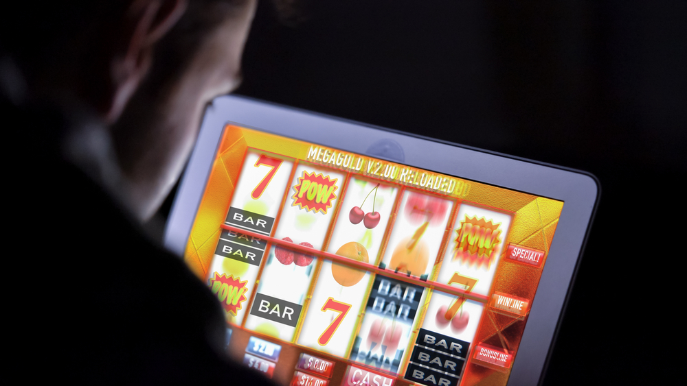 A gambler in front of an online casino slot