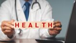 Doctor holding public health sign