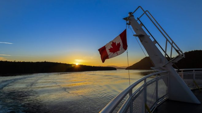 canadian flag boat sunset