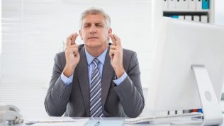 eyes closed fingers crossed