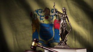 nj-flag-scales-justice-statue